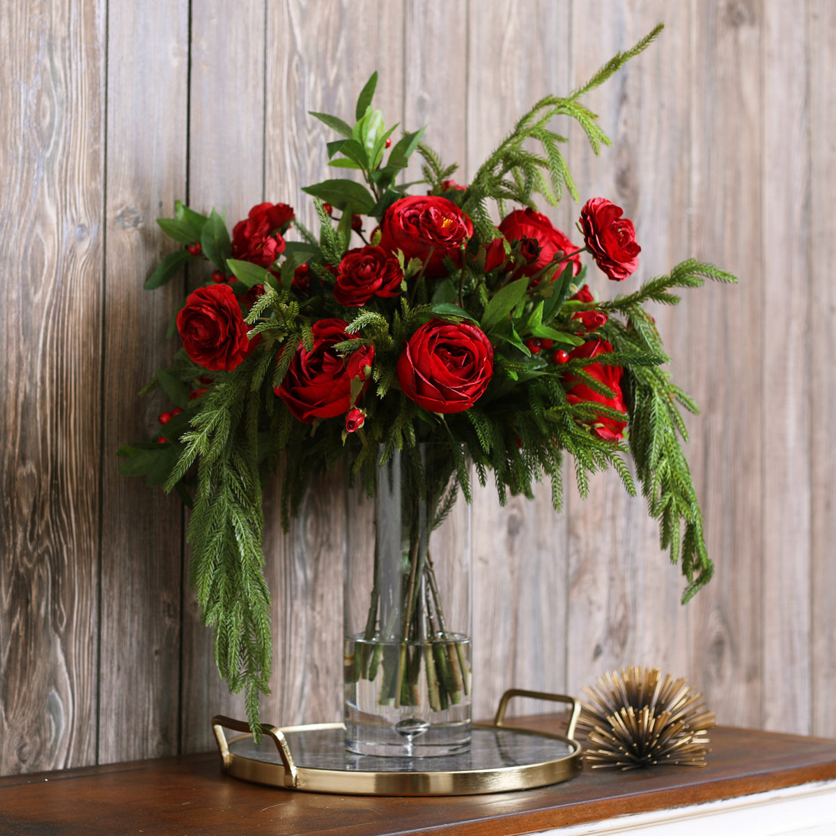 Holiday Grandeur - Red Rose, Ranunculus, Norfolk Pine & Laurel Draping  Christmas Floral Arrangement in Tall Glass Vase